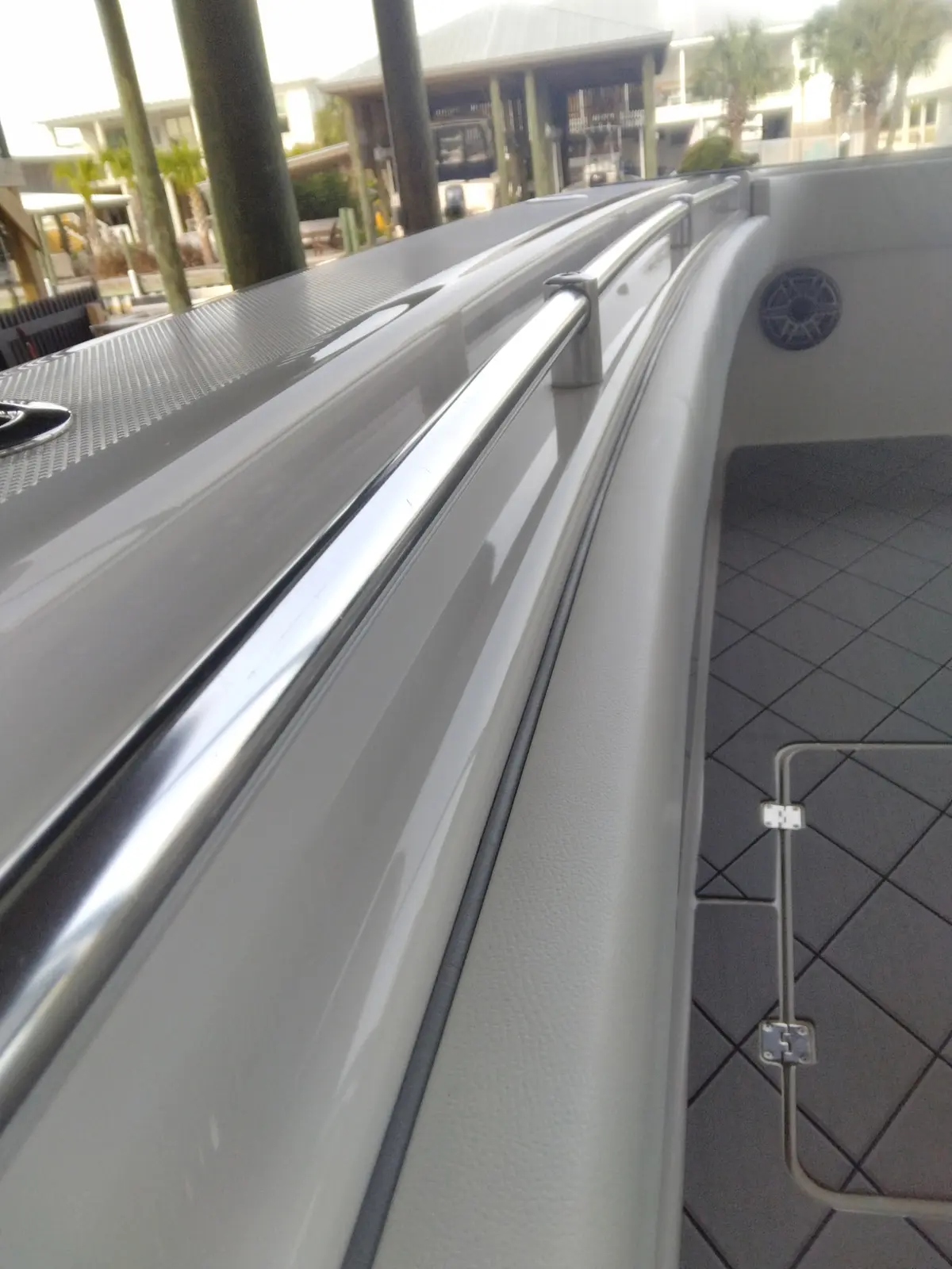 Glossy white and gray boat gunwale after detailing