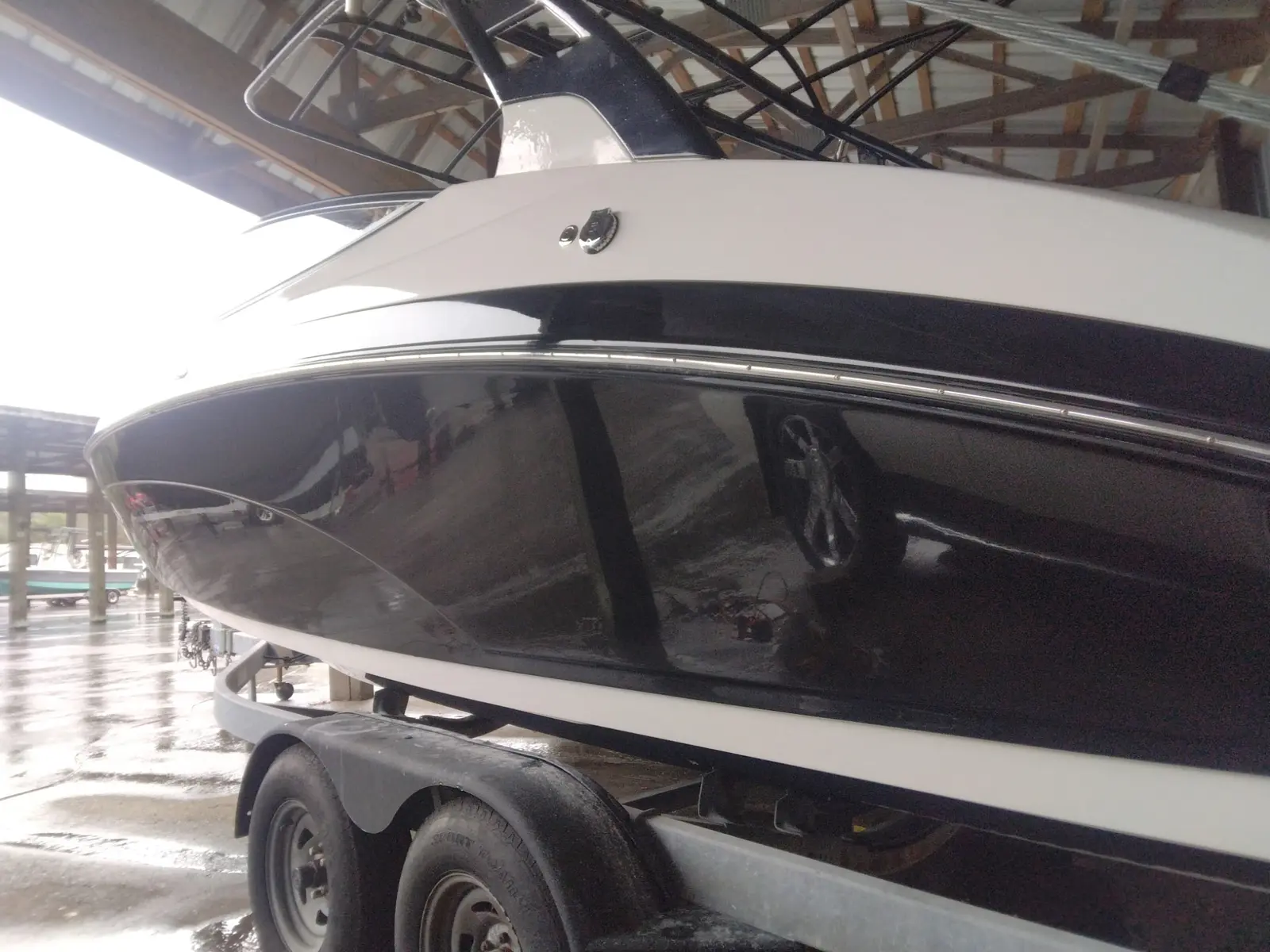 Shining black and white boat on a trailer