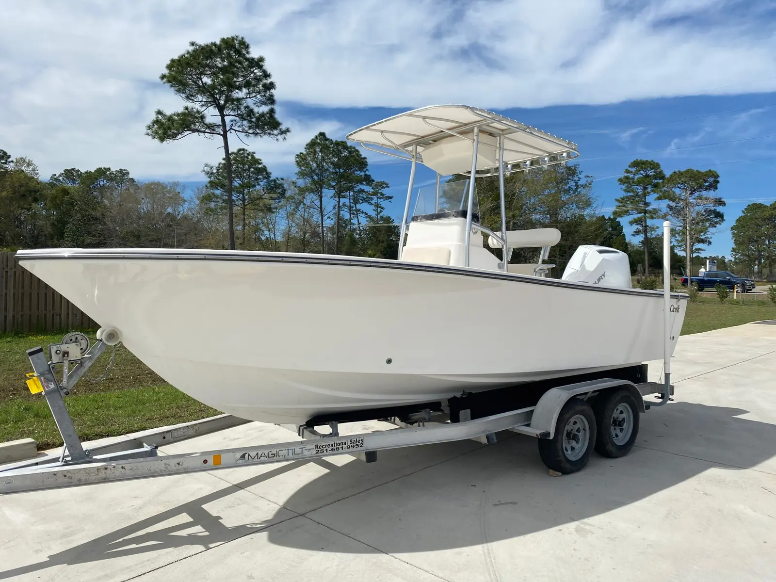 White fishing boat with a clean hull on a trailer