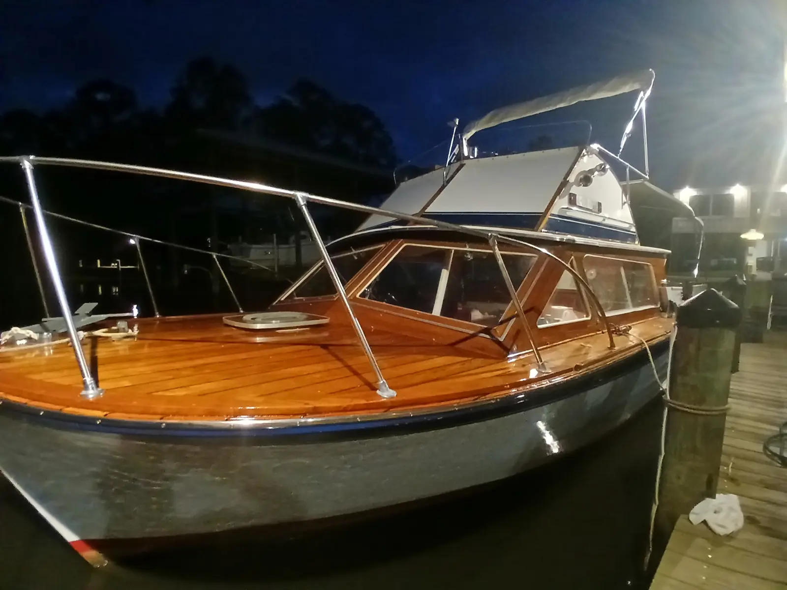 Glossy classic wooden boat at a marina after detailing